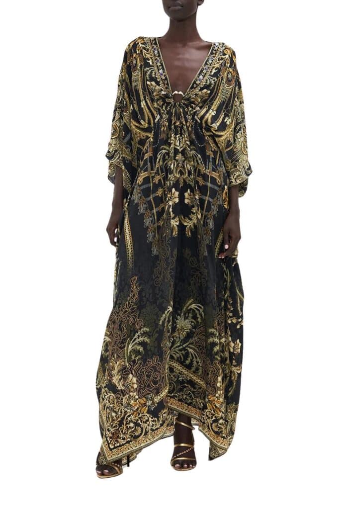 Front view of long silk kaftan on model from Camilla in black based print with gold highlights and hardware.