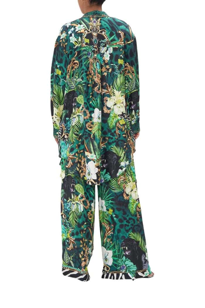 Back side of green floral print silk shirt from Camilla high summer 2023 collection with matching silk wide pants.